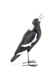 Timber Magpie with Metal legs, head up like they are wobbling.
