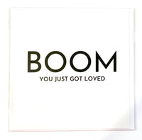 Card by Fierce One.  White card with white writing -  BOOM You Just Got Loved  Inside blank. Comes with white envelope.