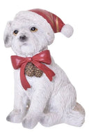 White Resin dog in a red bow and Santa hat