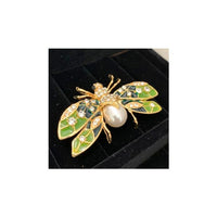 Butterfly brooch with green wings with crystal stones to highlight. Pearl body.