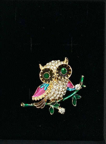 Beautiful Owl Brooch in Pinks and blue wings, sitting on a green branch. Dimensions 3.5cm x 4cm
