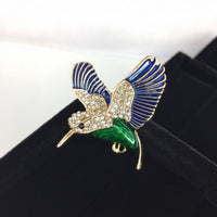 Beautiful bird in flight, green body with blue wings and crystal head