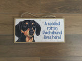 Sign with an image: A spoiled rotten Dachshund lives here! (Black and Tan Colour)