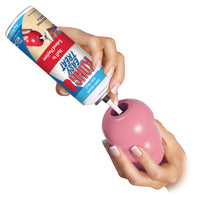 KONG Easy Treat Puppy Paste being sprayed inside KONG
